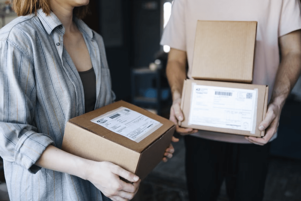 Ecommerce shipping workflow showing warehouse handling, carrier transport, and package delivery.