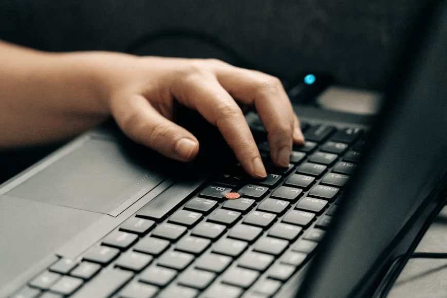 User checking official film classification records on a computer.